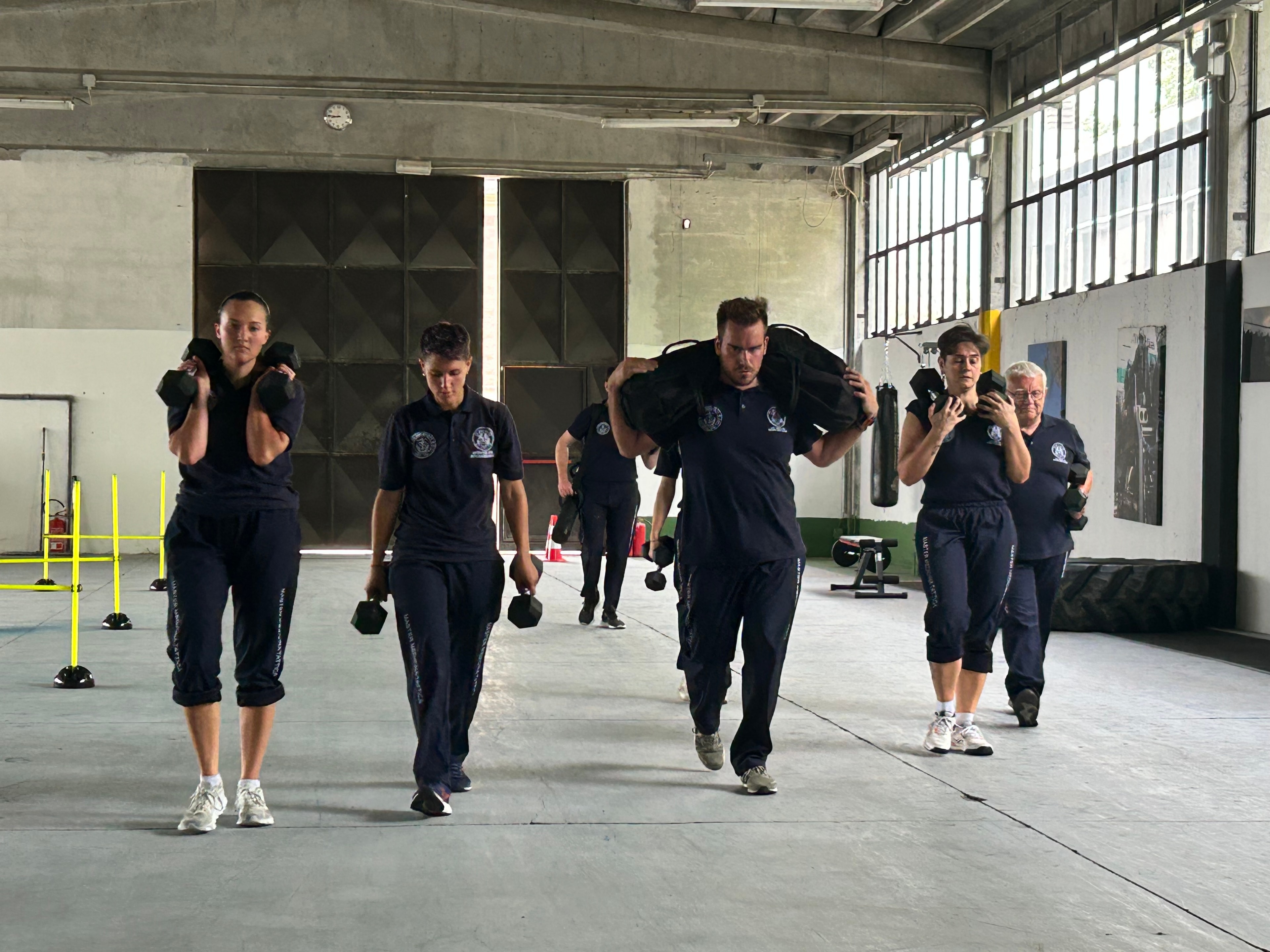 AREMT European Office — Master Medicina Tattica group fitness training with sandbags and dumbbells
