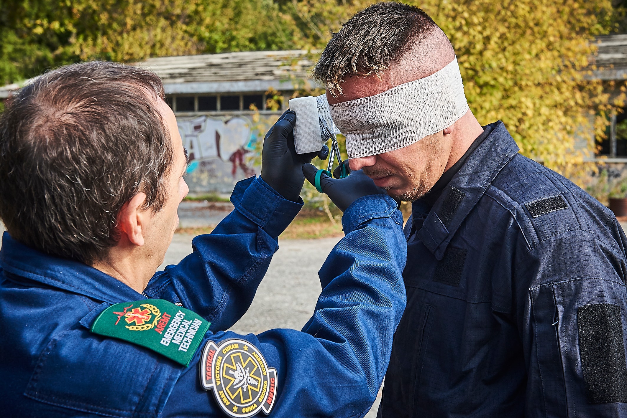 AREMT European Office — Tactical EMS close-up wound assessment and bandaging technique